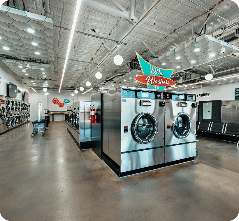 Clean and well-lit laundromat featuring 120 lb washers, ideal for handling bulk laundry in Arizona.