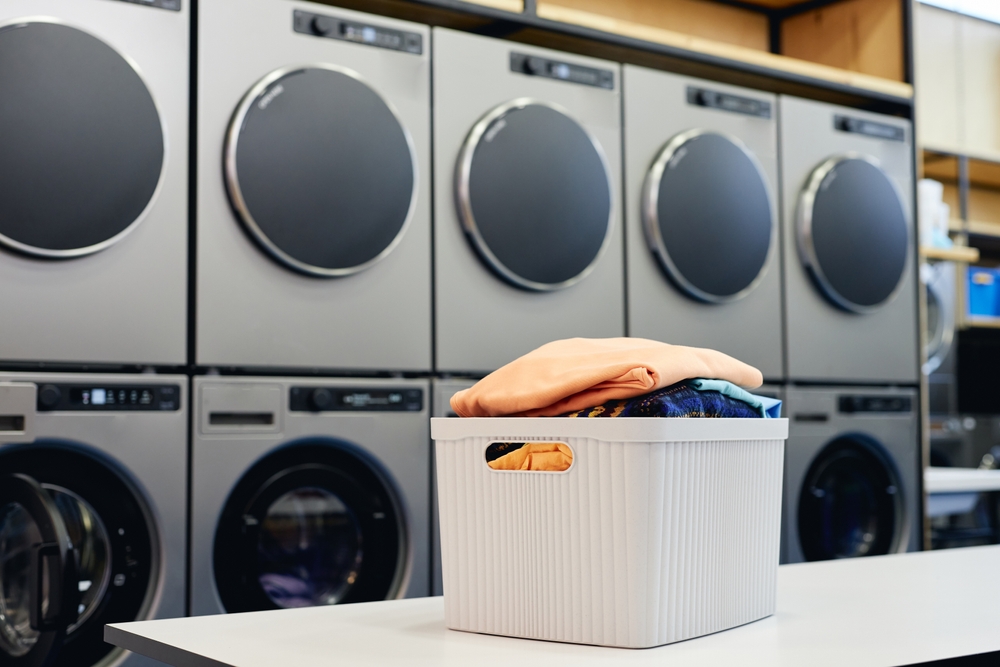 Still life shot of basket full of clean and fresh clothes on folding table