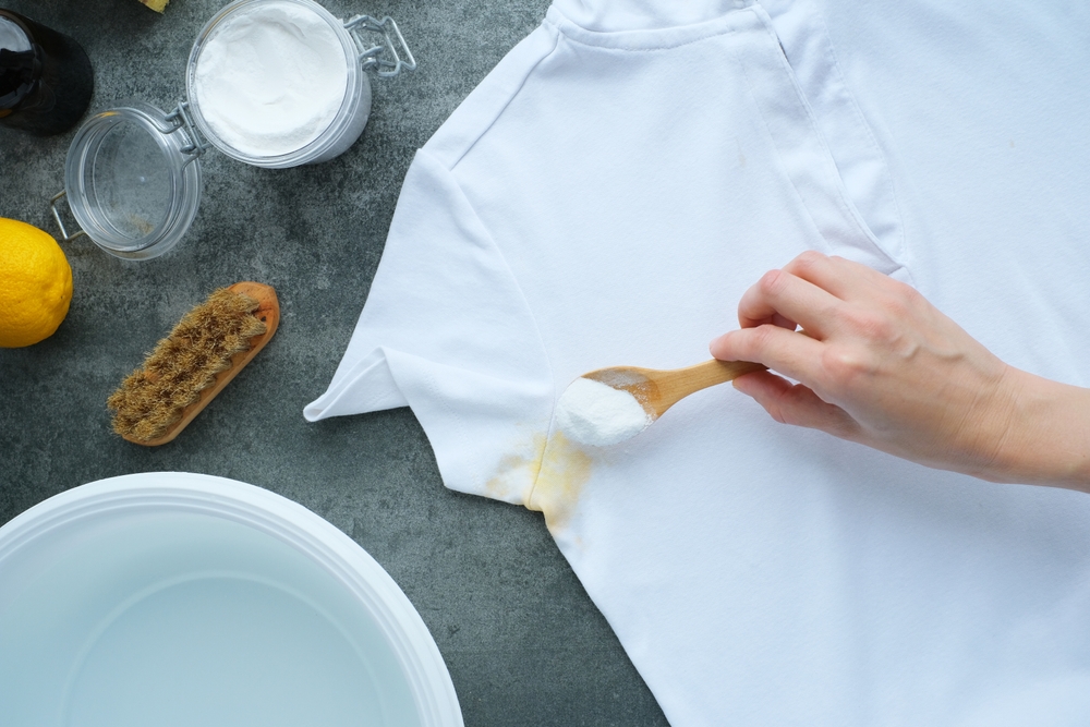 Woman's hand using baking soda powder for eco-friendly stain removal